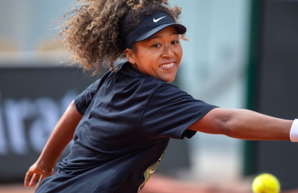 Naomi Osaka speaking at a climate change rally in 2025, championing environmental action